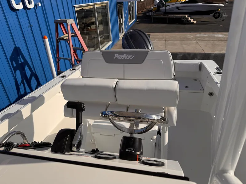 Slide: The Image of Parker 21 Special Edition boat interior, 2025 model, featuring white seating and steering console. - 10