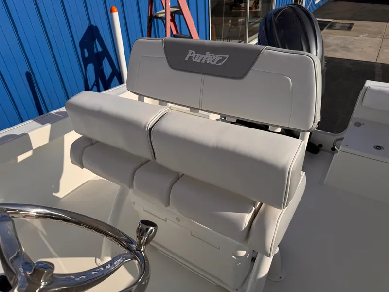 Slide: The Image of Parker 21 Special Edition 2025 boat seating with steering wheel, blue background. - 14