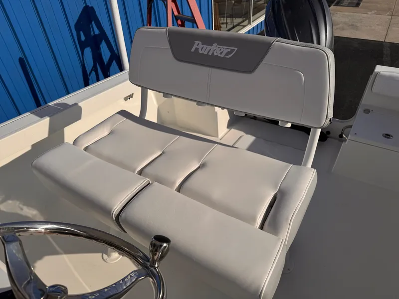 Slide: The Image of 2025 Parker 21 Special Edition boat seat with steering wheel, featuring white upholstery. - 16