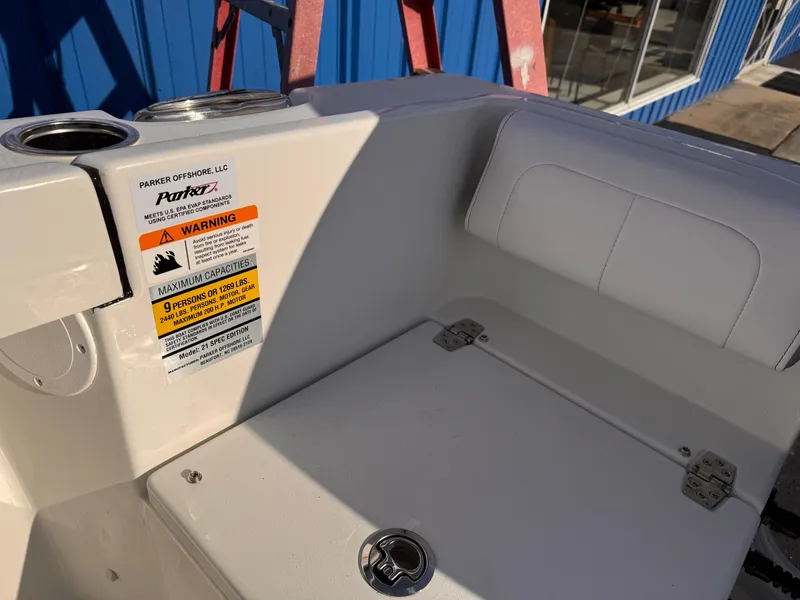 Slide: The Image of 2025 Parker 21 Special Edition boat interior with warning label and seating area. - 18