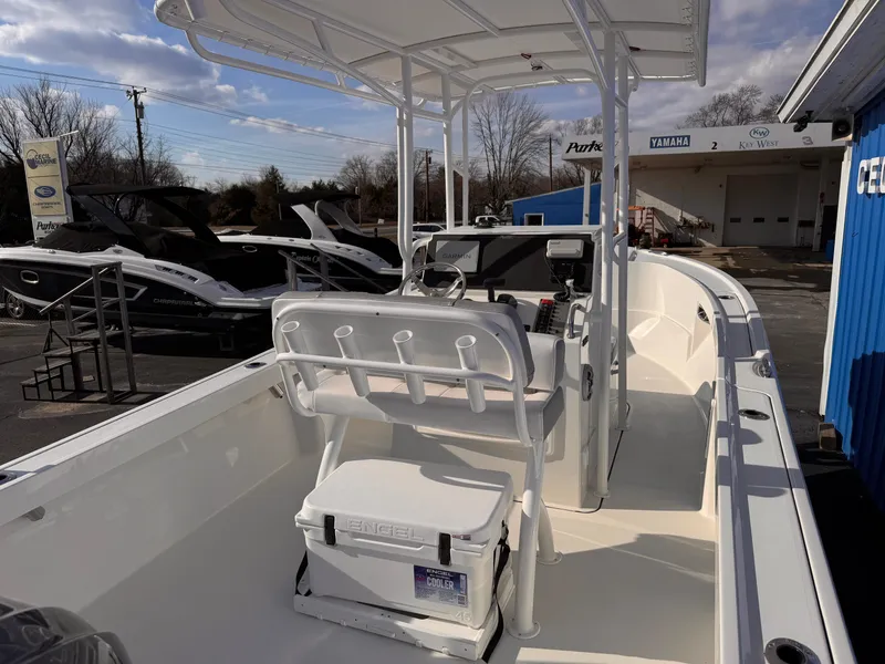 Slide: The Image of 2025 Parker 21 Special Edition boat with seating and console, displayed outdoors. - 21