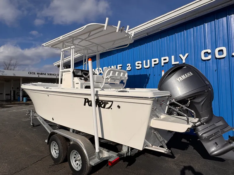 Slide: The Image of Parker 21 Special Edition 2025 boat on trailer, Yamaha engine, outside marine supply store. - 3