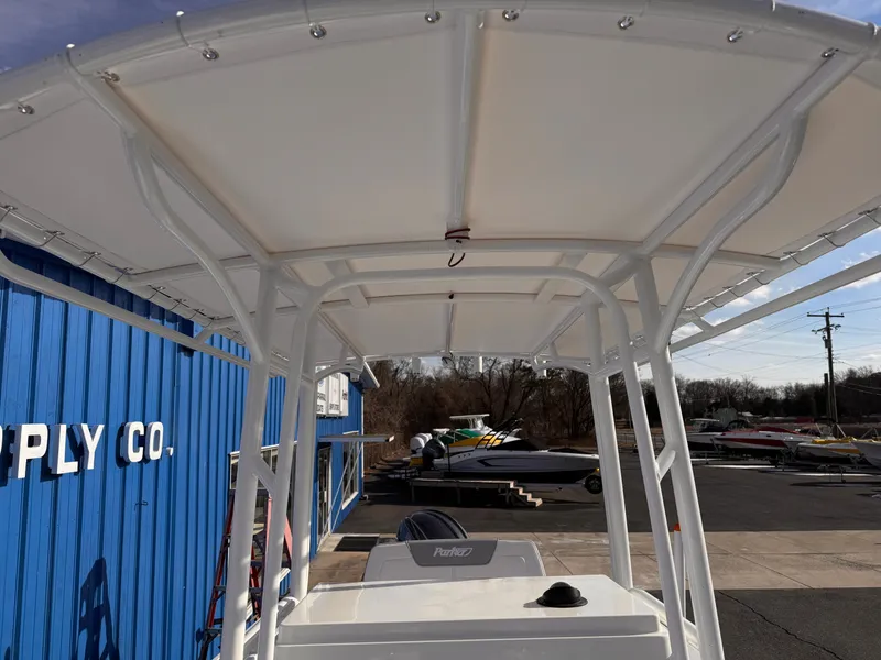 Slide: The Image of Parker 21 Special Edition boat, 2025 model, with a white canopy at a supply company. - 7