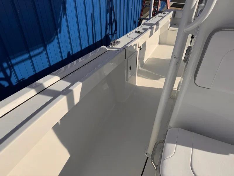 Slide: The Image of 2025 Parker 21 Special Edition boat interior with white seating and blue exterior. - 8