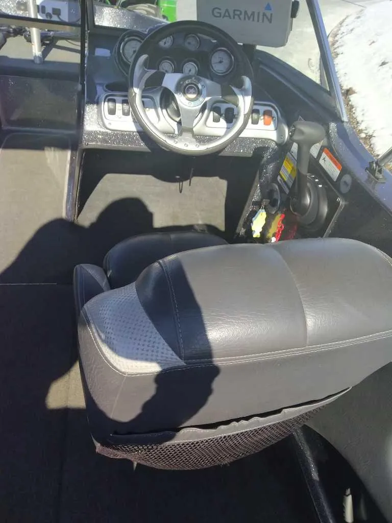 Slide: The Image of 2015 Stratos 486 SF boat interior with steering wheel and Garmin navigation system. - 4