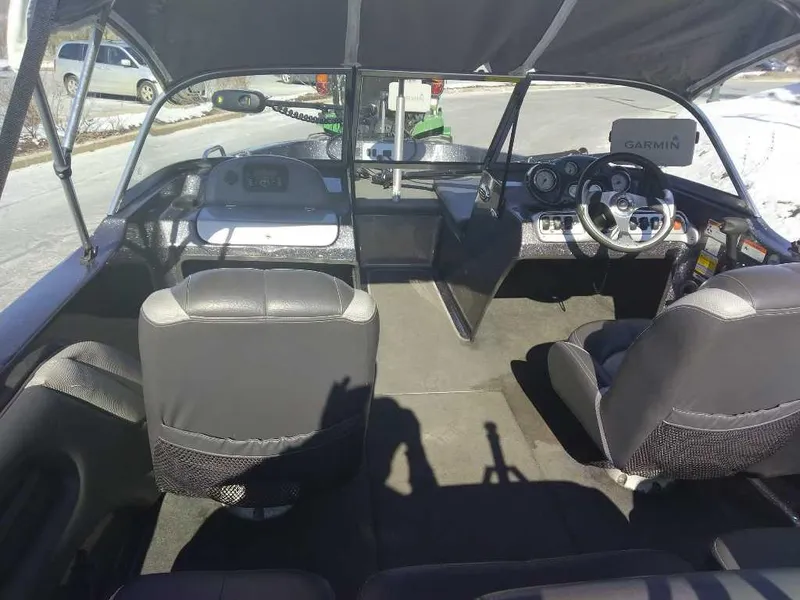 Slide: The Image of Interior of a 2015 Stratos 486 SF boat with seating and dashboard. - 5