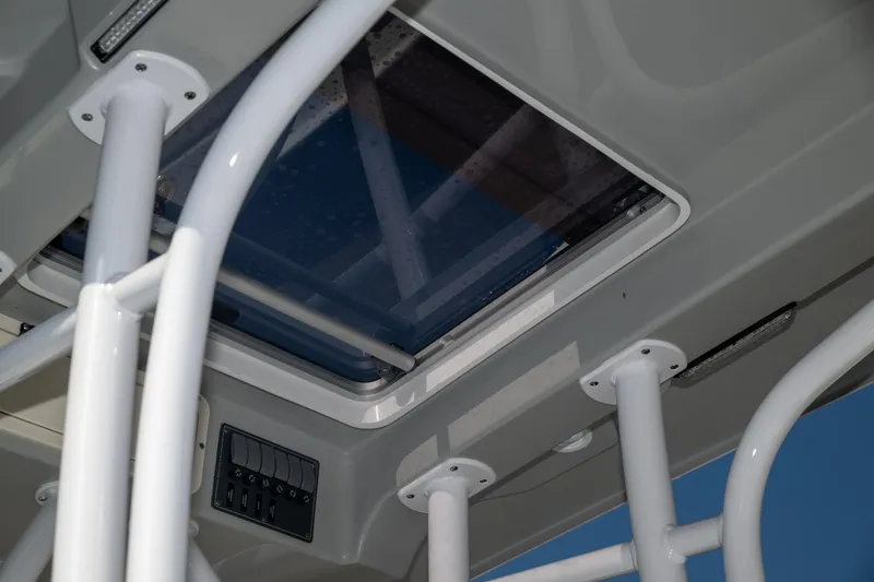 Slide: The Image of Contender 26 Bay 2025 boat interior with white framework and overhead hatch. - 11