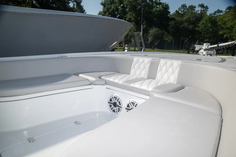 Slide: The Image of 2025 Contender 26 Bay boat interior with white seating and speakers. - 7