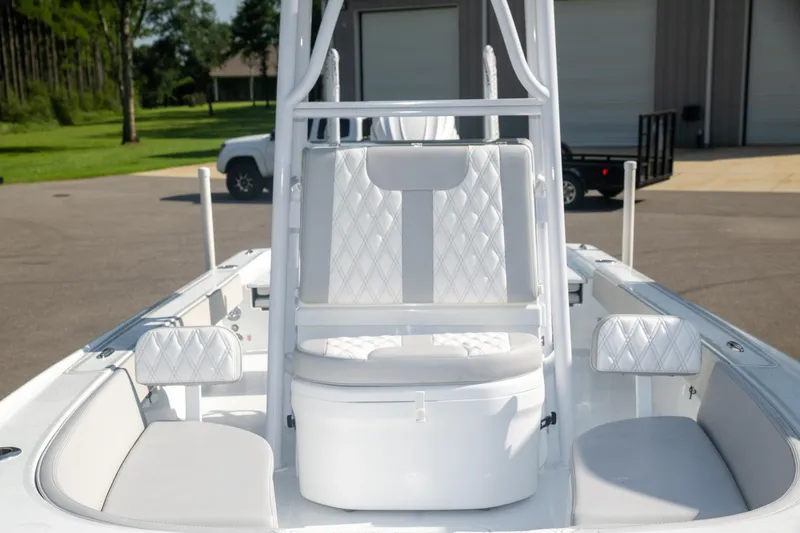 Slide: The Image of 2025 Contender 26 Bay boat interior with white seating and storage compartments. - 9