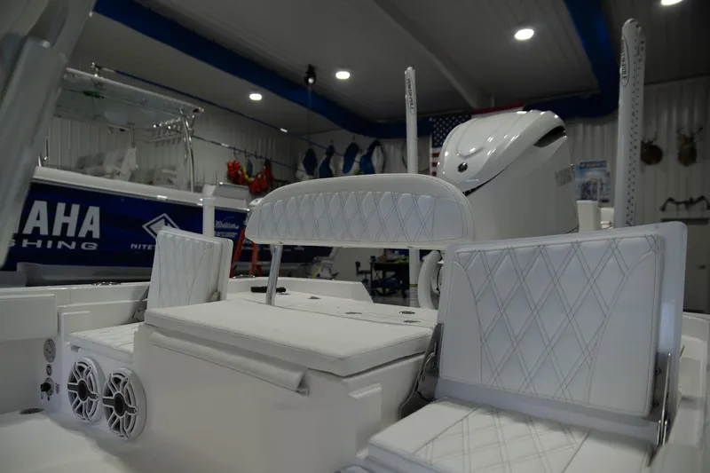Slide: The Image of 2025 Contender 26 Bay boat interior with Yamaha engine in showroom. - 2