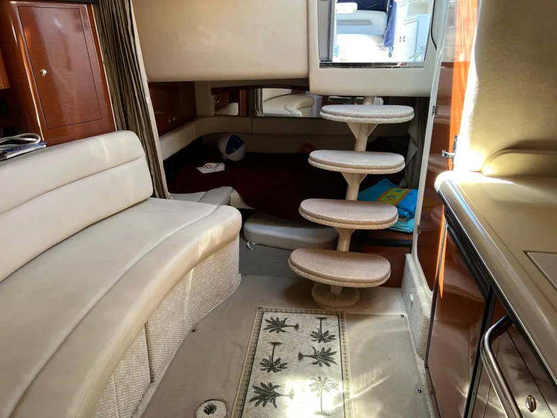 Slide: The Image of Interior of 2004 Sea Ray 340 Sundancer yacht with curved seating and spiral stairs. - 11