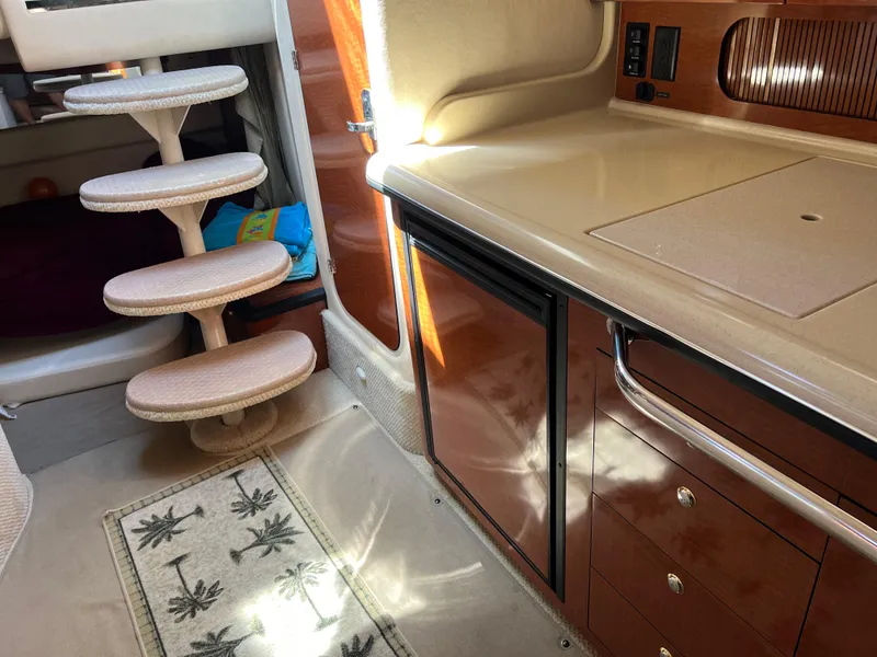Slide: The Image of Interior of 2004 Sea Ray 340 Sundancer with kitchenette and spiral stairs. - 13