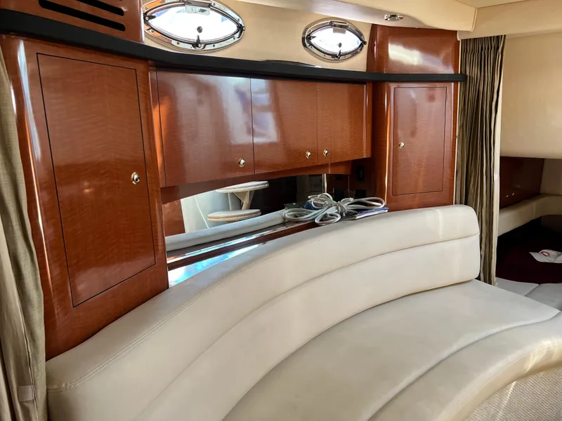 Slide: The Image of Interior of 2004 Sea Ray 340 Sundancer with wood cabinets and curved seating. - 17