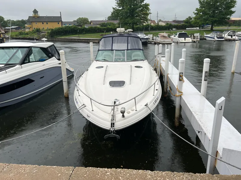 Slide: The Image of 2004 Sea Ray 340 Sundancer docked at marina, front view. - 2