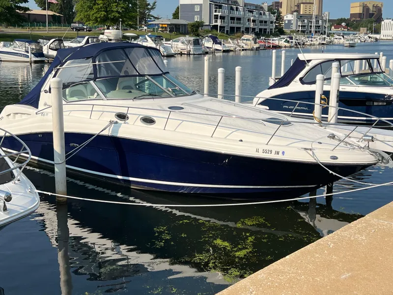 Slide: The Image of 2004 Sea Ray 340 Sundancer docked at marina, surrounded by other boats. - 4