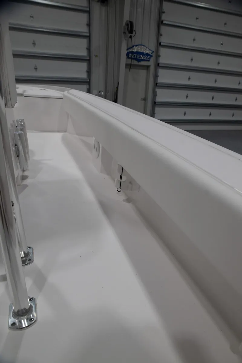 Slide: The Image of 2024 Contender 23 Bay boat interior detail in a garage setting. - 6