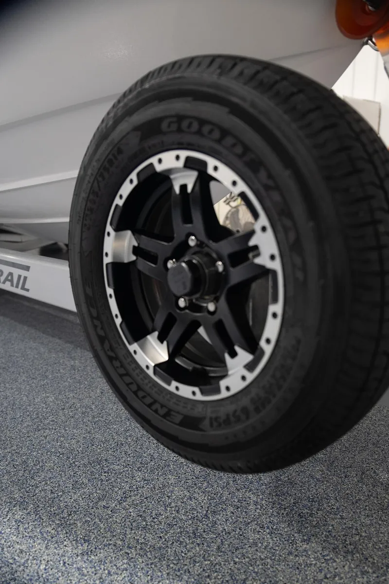 Slide: The Image of 2024 Contender 23 Bay trailer wheel with Goodyear tire, close-up view. - 9