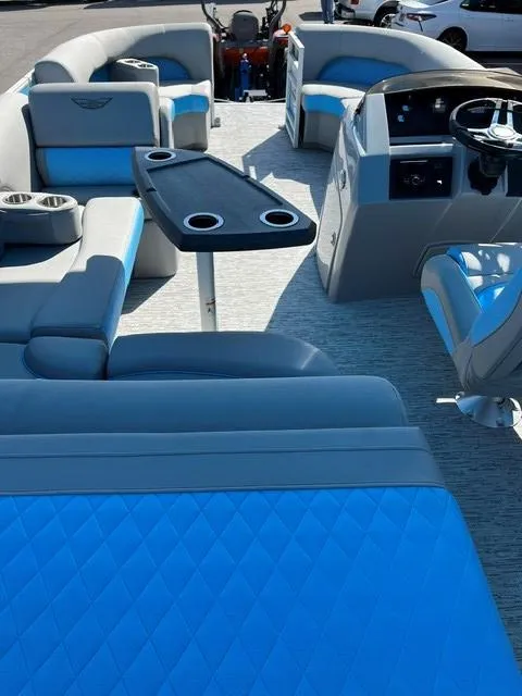 Slide: The Image of 2025 Bennington 20L Cruise pontoon boat interior with blue seating and modern dashboard. - 4