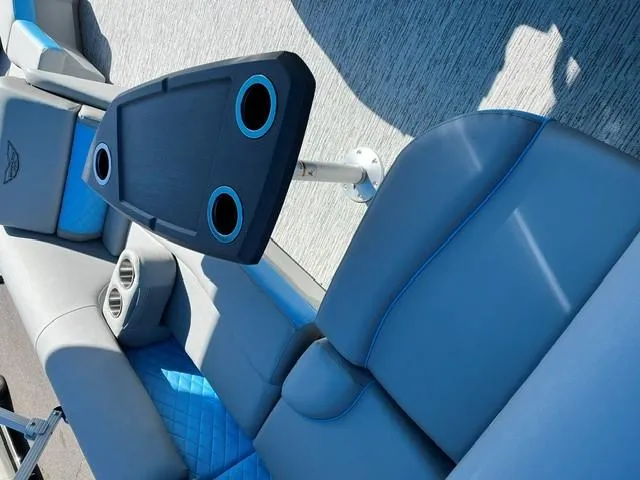 Slide: The Image of 2025 Bennington 20L Cruise interior with blue seating and cup holders. - 6