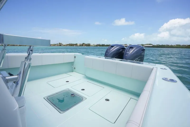 Slide: The Image of 2024 Contender 35 ST boat with dual engines on calm water. - 11