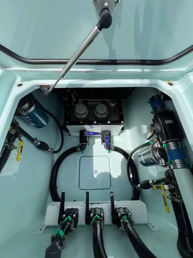 Slide: The Image of 2024 Contender 35 ST boat compartment with hoses and mechanical components. - 13