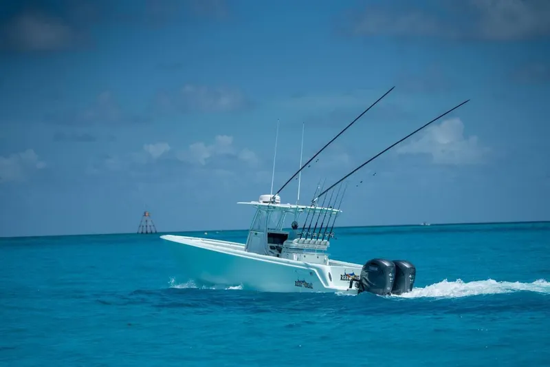 Slide: The Image of 2024 Contender 35 ST boat cruising on clear blue ocean waters. - 2