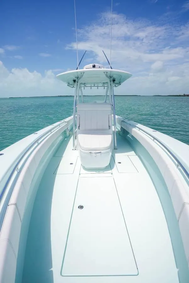Slide: The Image of 2024 Contender 35 ST boat on calm turquoise water under a clear blue sky. - 8