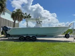Slide: The Image of 2023 Contender 35 ST boat on trailer, parked outdoors under a blue sky. - 0