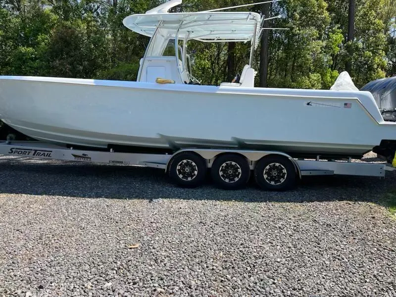 Slide: The Image of 2023 Contender 35 ST boat on a trailer, parked outdoors. - 15