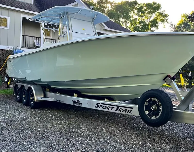 Slide: The Image of 2023 Contender 35 ST boat on Sport Trail trailer, parked outdoors. - 17