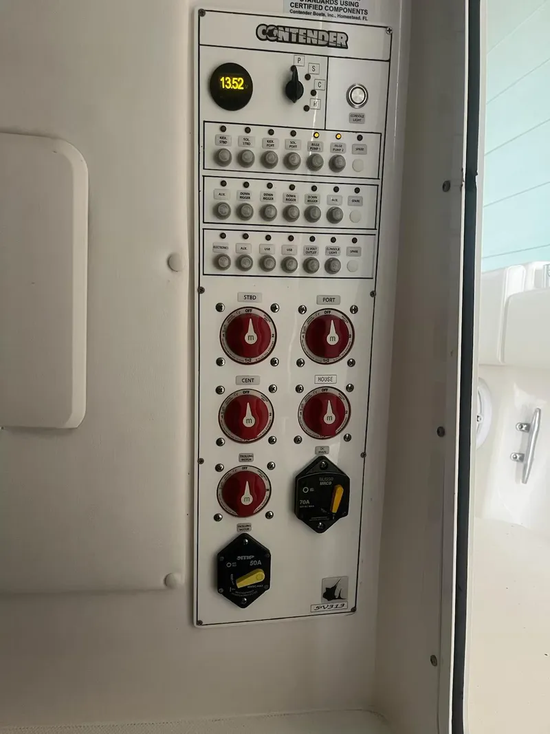 Slide: The Image of Control panel of 2023 Contender 35 ST boat with switches and indicators. - 22