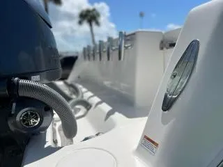 Slide: The Image of 2023 Contender 35 ST boat interior with engine and rod holders, under a clear blue sky. - 30