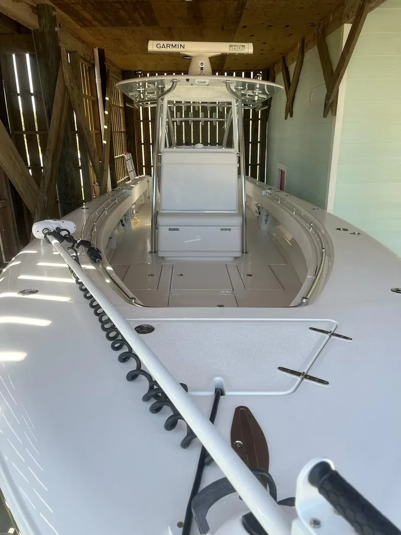 Slide: The Image of 2023 Contender 35 ST boat in a wooden boathouse, featuring a sleek design and advanced equipment. - 31