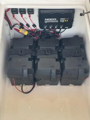 Slide: The Image of Battery compartment of 2023 Contender 35 ST with NOCO Genius GENPRO 10x4 charger. - 33