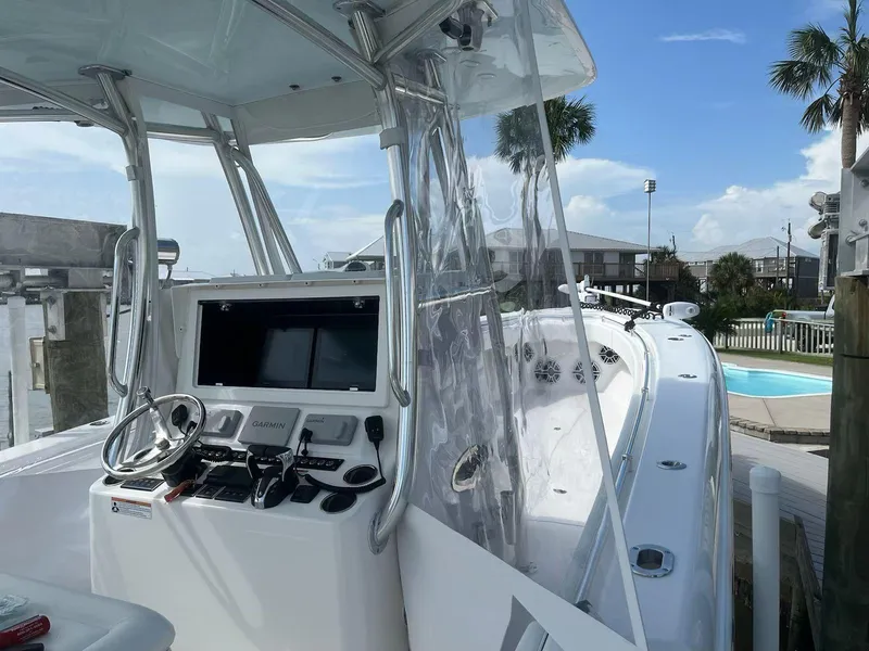 Slide: The Image of 2023 Contender 35 ST boat cockpit with modern navigation equipment and clear skies. - 35