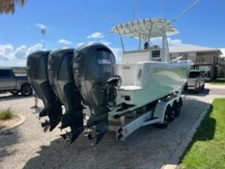 Slide: The Image of 2023 Contender 35 ST boat with triple Yamaha outboard engines on a trailer. - 5