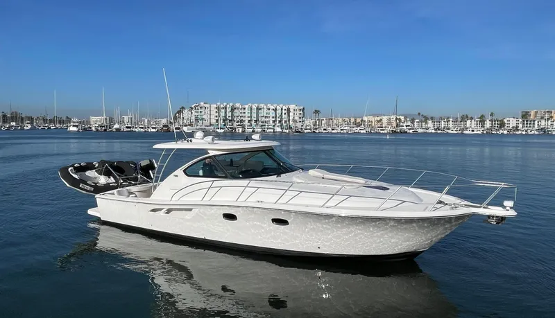 Slide: The Image of 2013 Tiara Yachts 3900 Open cruising in a marina with clear blue skies. - 0