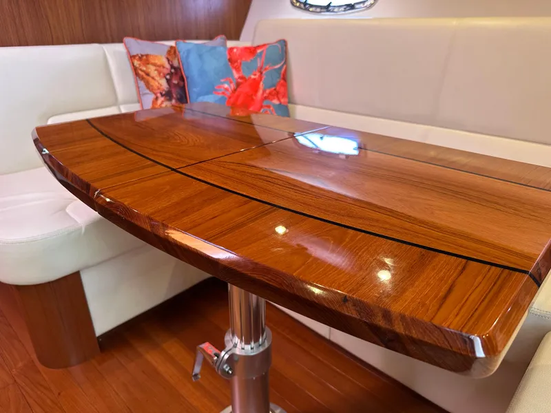 Slide: The Image of Luxurious interior of 2013 Tiara Yachts 3900 Open with polished wood table and plush seating. - 10