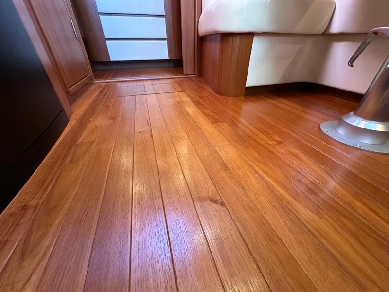 Slide: The Image of Interior view of 2013 Tiara Yachts 3900 Open with polished wooden flooring. - 11