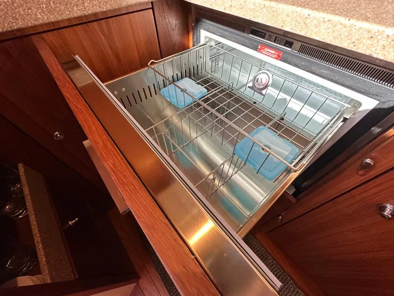 Slide: The Image of 2013 Tiara Yachts 3900 Open galley with open stainless steel dishwasher drawer. - 12