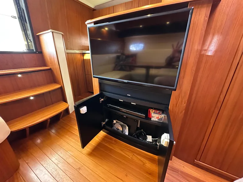 Slide: The Image of Entertainment center with TV and storage in 2013 Tiara Yachts 3900 Open interior. - 13