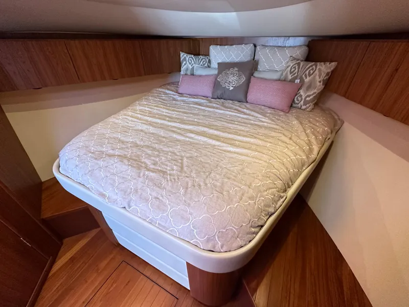 Slide: The Image of Cozy bedroom in 2013 Tiara Yachts 3900 Open with elegant bedding and wood accents. - 14