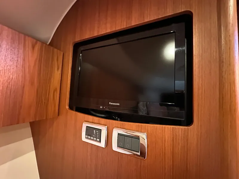 Slide: The Image of Built-in TV and control panel on 2013 Tiara Yachts 3900 Open. - 15
