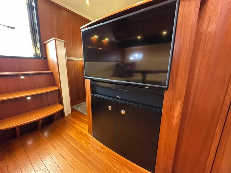 Slide: The Image of Interior of 2013 Tiara Yachts 3900 Open with wood paneling and flat-screen TV. - 16