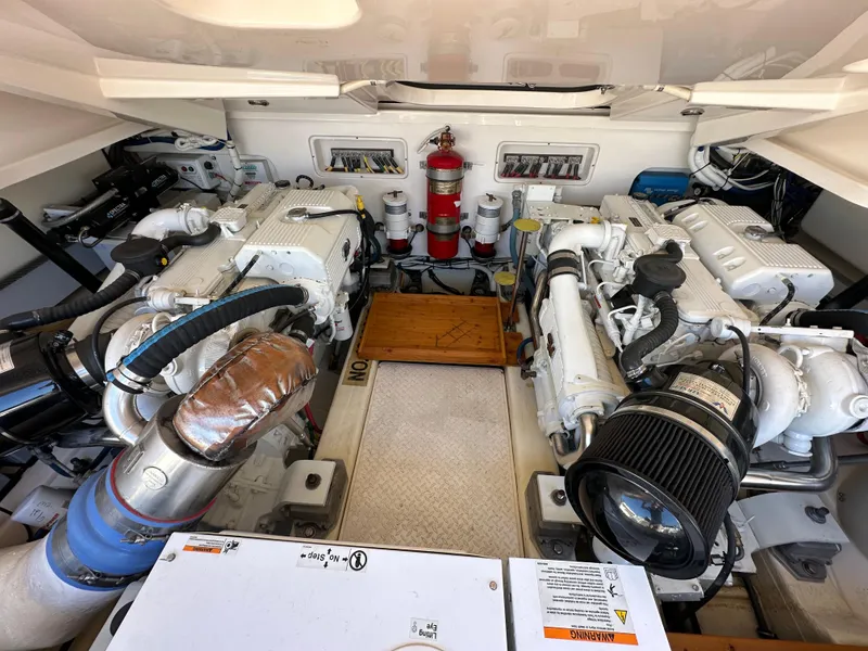 Slide: The Image of Engine room of 2013 Tiara Yachts 3900 Open, featuring dual engines and safety equipment. - 19