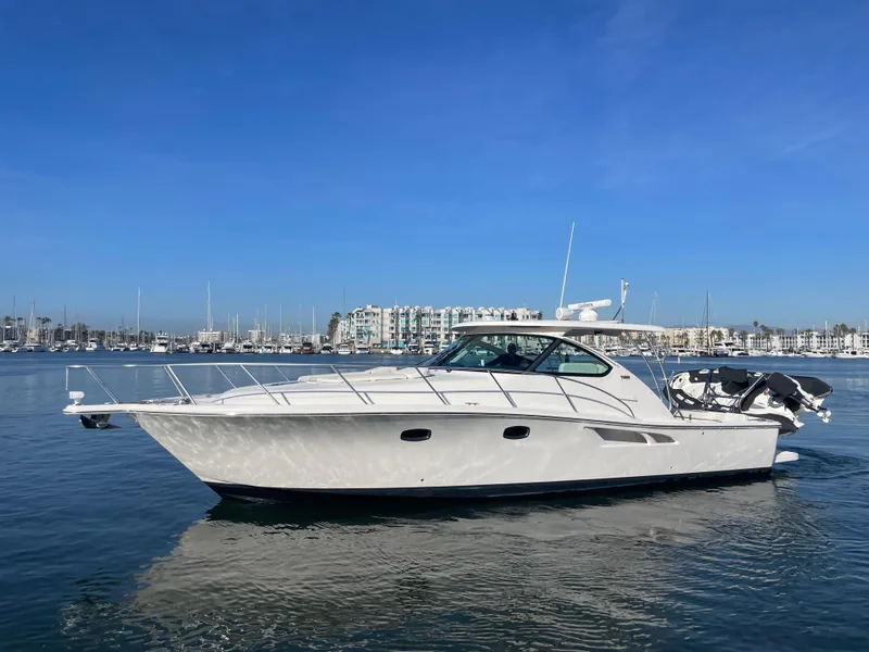 Slide: The Image of 2013 Tiara Yachts 3900 Open cruising on calm waters under a clear blue sky. - 2
