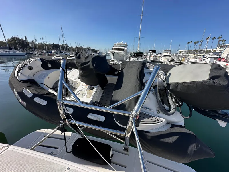 Slide: The Image of 2013 Tiara Yachts 3900 Open with inflatable boat on deck, docked in marina. - 23