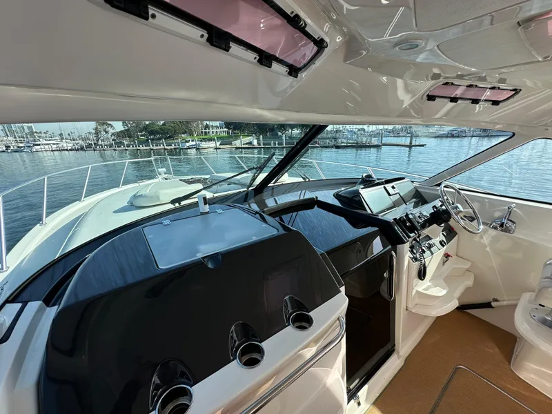 Slide: The Image of 2013 Tiara Yachts 3900 Open cockpit with modern controls and waterfront view. - 33