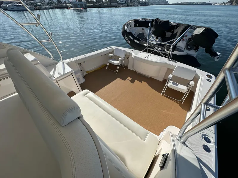 Slide: The Image of 2013 Tiara Yachts 3900 Open cockpit with seating, docked near water. - 36