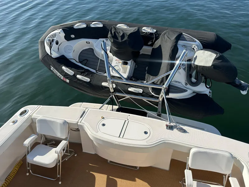 Slide: The Image of Tiara Yachts 3900 Open 2013 with inflatable boat on water, viewed from deck. - 37